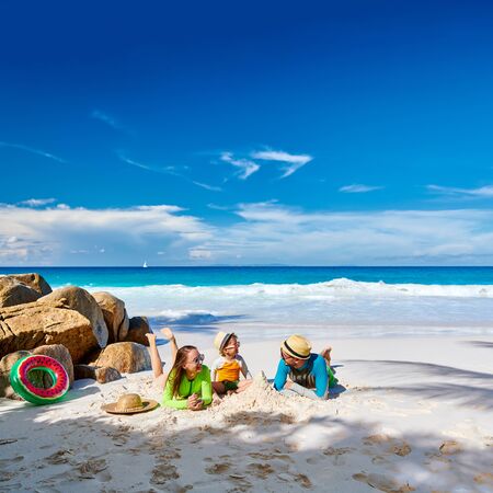 Family on beach, young couple with three year old boy. Summer vacation at Seychelles.の写真素材