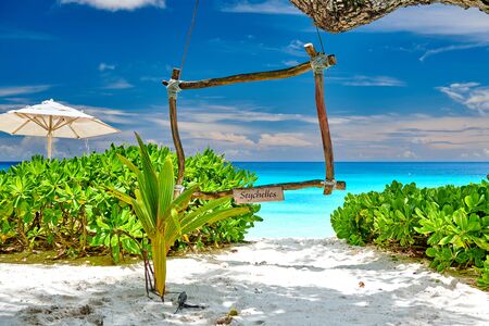 Beautiful Petite Anse beach with wooden frame at Seychelles, Maheの写真素材