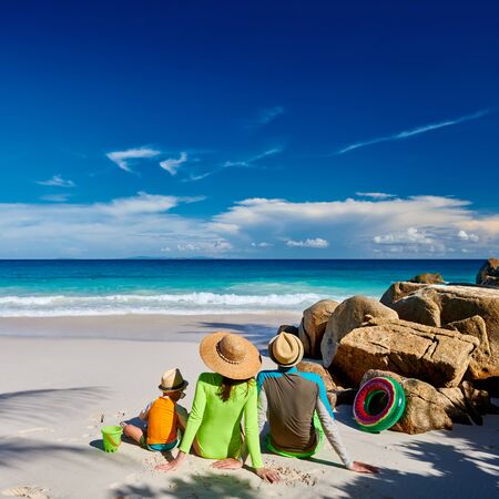 Family on beach, young couple with three year old boy. Summer vacation at Seychelles.の写真素材