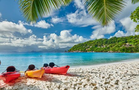Beautiful Petite Anse beach with kayaks and palm tree at Seychelles, Maheの写真素材