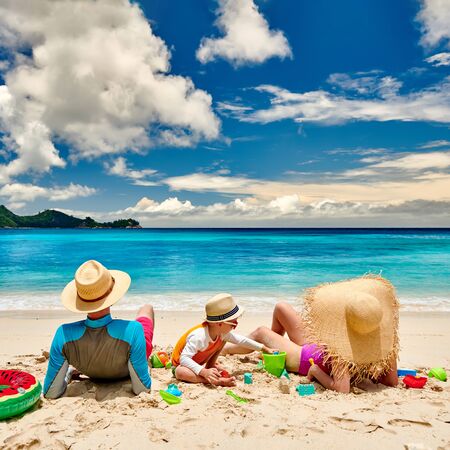 Family on beach, young couple with three year old boy. Summer vacation at Seychelles.の写真素材