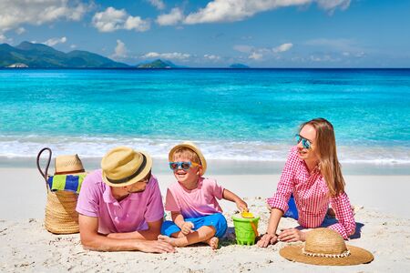 Family on beautiful Anse Soleil beach, young couple with three year old toddler boy. Summer vacation at Seychelles, Mahe.の写真素材