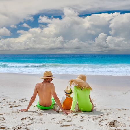 Family on beach, young couple with three year old boy. Summer vacation at Seychelles.の写真素材