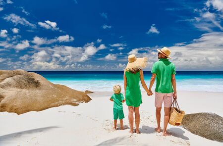 Family on beautiful Anse Intendance beach, young couple in green with three year old toddler boy. Summer vacation at Seychelles, Mahe.の写真素材