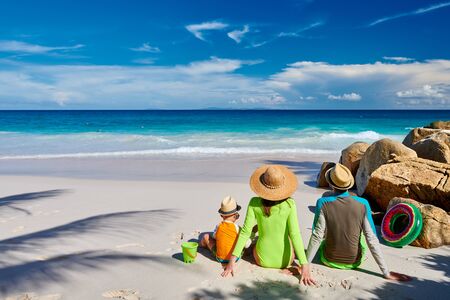 Family on beach, young couple with three year old boy. Summer vacation at Seychelles.の写真素材