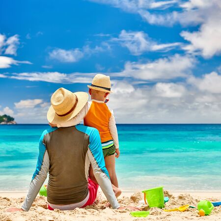 Three year old toddler boy on beach with father. Summer family vacation at at Seychelles, Mahe.の写真素材