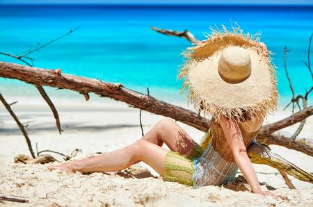 Woman sitting on beach at Seychelles, Maheの写真素材