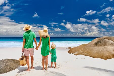 Family on beautiful Anse Intendance beach, young couple in green with three year old toddler boy. Summer vacation at Seychelles, Mahe.の写真素材