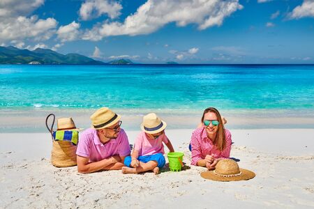 Family on beautiful Anse Soleil beach, young couple with three year old toddler boy. Summer vacation at Seychelles, Mahe.の写真素材