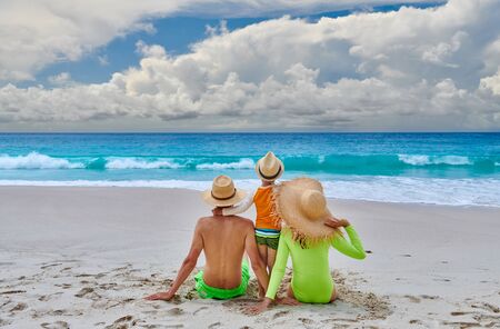 Family on beach, young couple with three year old boy. Summer vacation at Seychelles.の写真素材