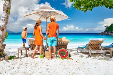 Family on beautiful Petite Anse beach, young couple with three year old toddler boy. Summer vacation at Seychelles, Mahe.の写真素材