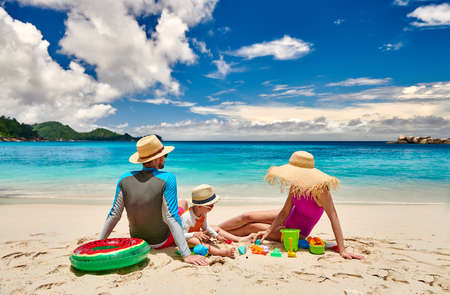 Family on beach, young couple with three year old boy. Summer vacation at Seychelles.の写真素材