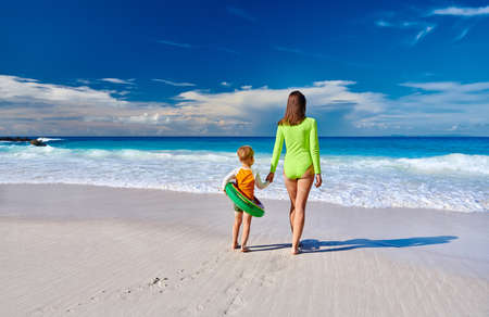 Three year old toddler boy on beach with mother. Summer family vacation at at Seychelles, Mahe.の写真素材