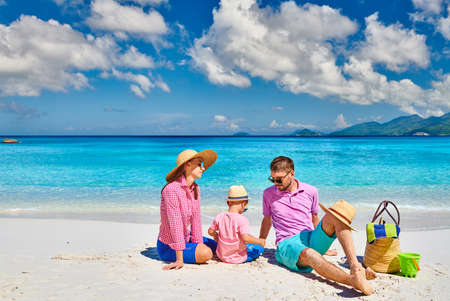 Family on beautiful Anse Soleil beach, young couple with three year old toddler boy. Summer vacation at Seychelles, Mahe.の写真素材