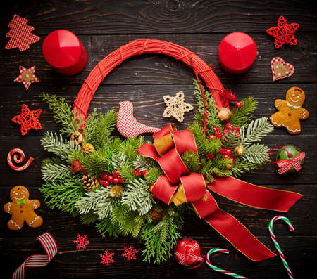 Christmas wreath and candles on dark rustic wooden backgroundの写真素材