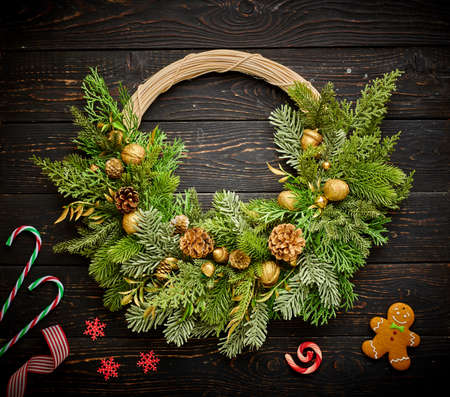 Christmas wreath and candles on dark rustic wooden backgroundの写真素材