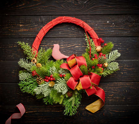 Christmas wreath and candles on dark rustic wooden backgroundの写真素材