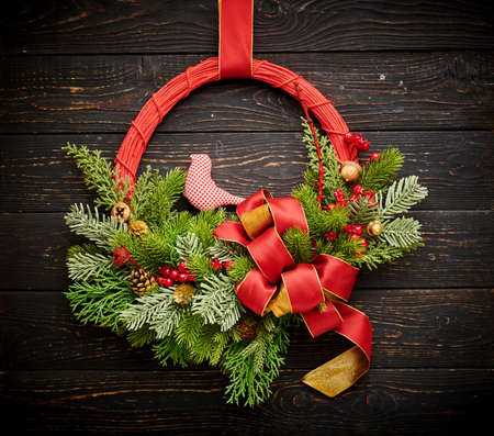 Christmas wreath on dark rustic wooden backgroundの写真素材