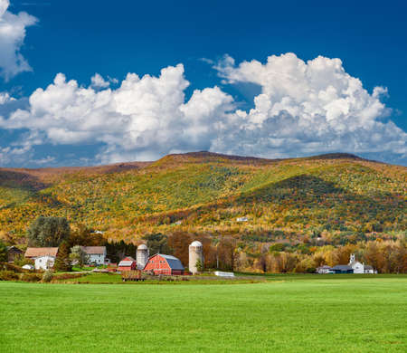 Farm with red barn and silos at sunny autumn day in West Arlington, Vermont, USA