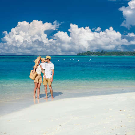 Family on beach, young couple with three year old boy. Summer vacation at Maldives.の写真素材