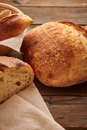 Freshly baked homemade tartine bread on wooden tableの写真素材