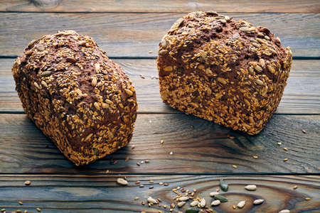Freshly baked homemade bread on dark wooden tableの写真素材