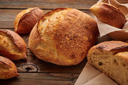 Freshly baked homemade tartine bread on wooden tableの写真素材