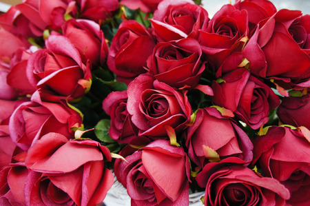 Artificial red roses in white basketの写真素材