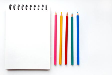 Note for drawing and colour pencils on white background.