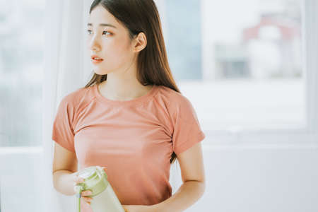 portrait of asian woman practicing yoga at homeの写真素材