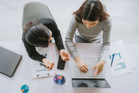 top-down image of two Asian women working togetherの写真素材