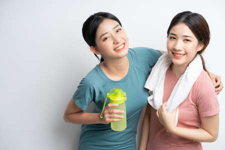 portrait of two asian women wearing gym clothesの写真素材