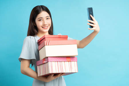 portrait of asian woman holding gift boxの写真素材