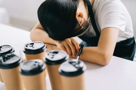 The Asian coffee shop owner is upset because their shops were closed due to the effects of the diseaseの写真素材