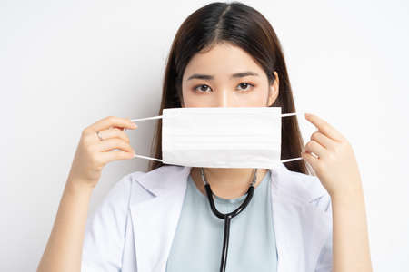 portrait of female doctor instructing to wear a mask properlyの写真素材