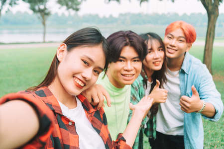 photo of group of happy asian friends taking a selfie togetherの写真素材