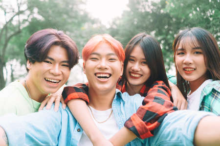photo of group of happy asian friends taking a selfie togetherの写真素材