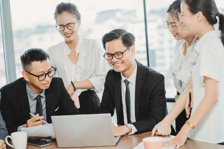 Business team leader presents to employees about upcoming work plansの写真素材