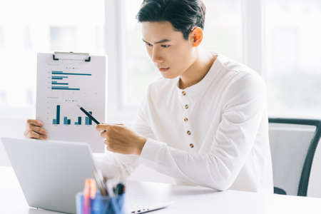 Asian businessman are participating in online meeting with his team via video callの写真素材