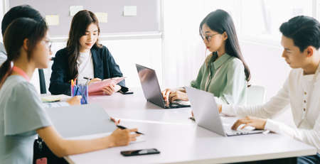 The business team members are discussing next month's plans together