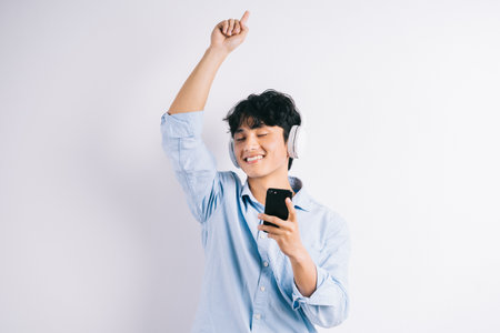 Asian man is listening to music and repeatの写真素材