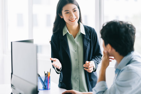 The young female director is guiding the staff to implement the year-end planの写真素材