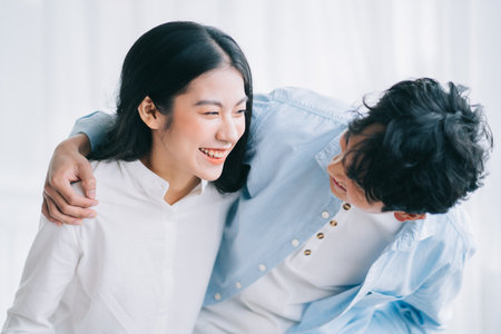 Asian couple happily embracing each otherの写真素材