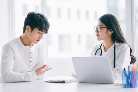 Asian female doctor is checking on the patient's healthの写真素材