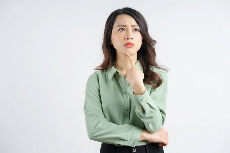 Portrait of a beautiful Asian businesswoman with a thinking lookの写真素材