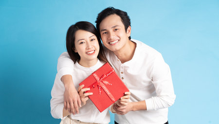 Asian boyfriend gives gifts to his girlfriend on Valentine's Day