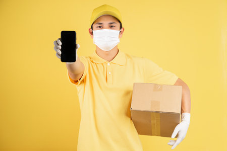 Portrait of male deliveryman wearing mask during epidemic season on background
