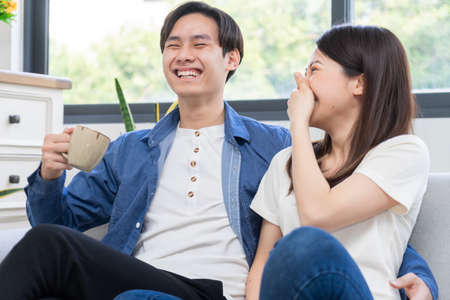 Young Asian couple chatting happilyの写真素材