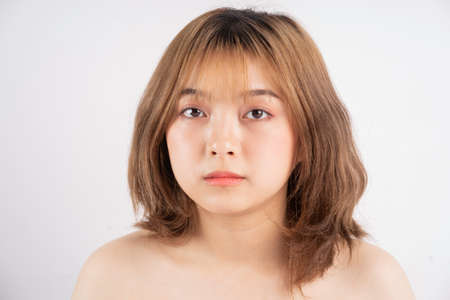 Beautiful xing woman with fresh skin smiling on backgroundの写真素材