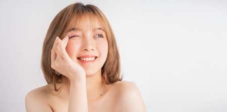 Beautiful xing woman with fresh skin smiling on backgroundの写真素材